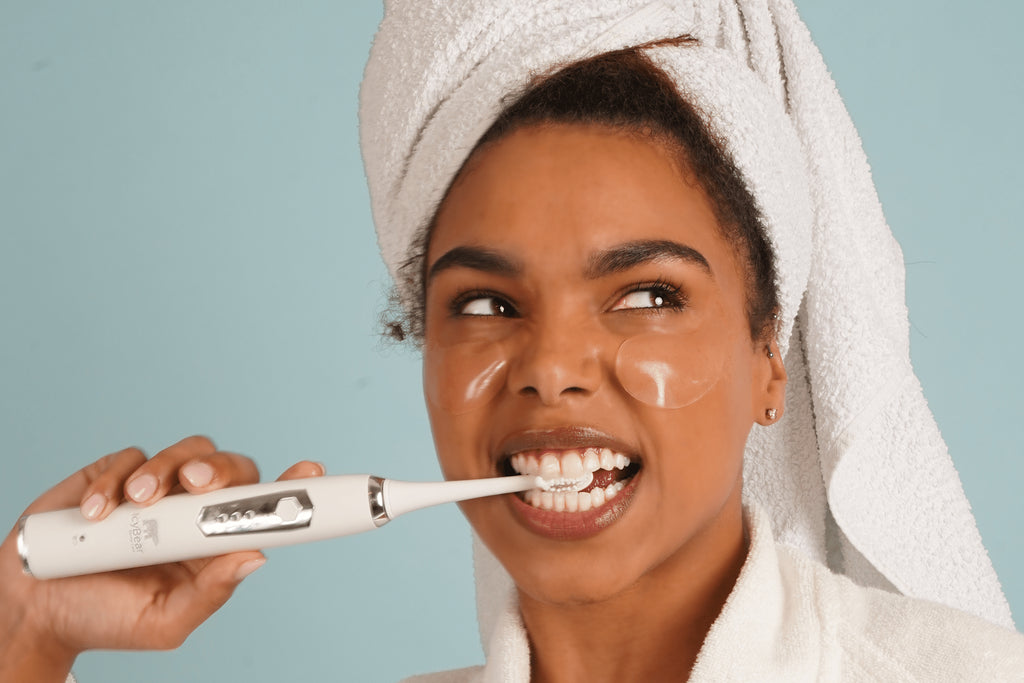 icy bear model holding sonic toothbrush